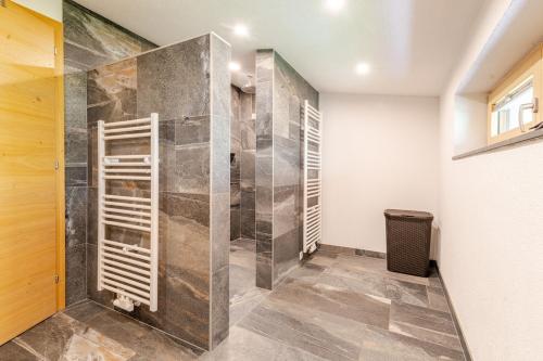 a walk in shower in a room with a glass door at Ferienwohnung La-Wurm mit privatem Whirlpool in Hart im Zillertal