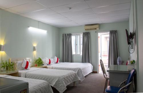 a hotel room with two beds and a window at QUANG SAIGON Hotel- 40-7 Bùi Viện-Walking street in Ho Chi Minh City