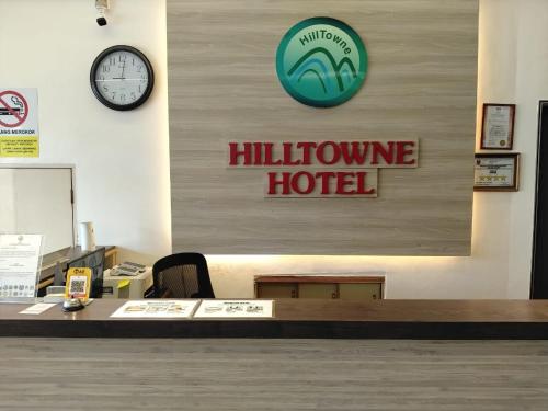 a lobby of a hotel with a clock on the wall at Hotel O Hilltowne in Kampong Kawak