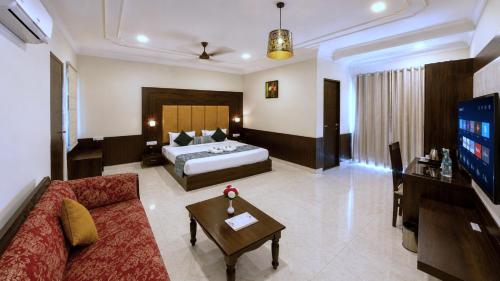 a living room with a bed and a couch at Red Tullip Md Valley Resort & Spa - Luxury Resort With Swimming Pool, Udaipur in Udaipur