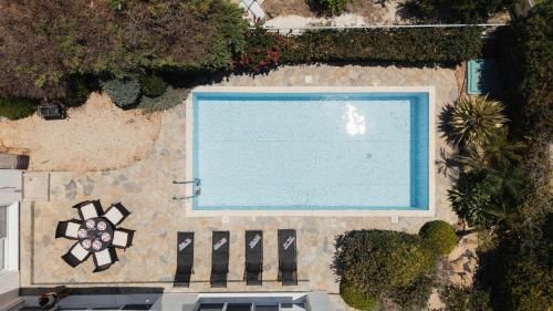 an overhead view of a swimming pool with a sidx sidx sidx at 3BR Panoramic Sea View Villa with Private Pool by Cyprus Horizons in Pissouri