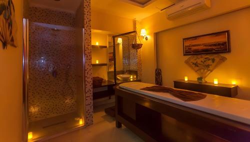 a bathroom with a tub and a shower with a sink at Linda Sunny Beach Hotel & Spa-Ultra All Inclusive in Side