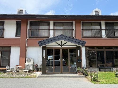 a building with a revolving door with a table and chairs at Yamanaka Lake Ryozan in Yamanakako