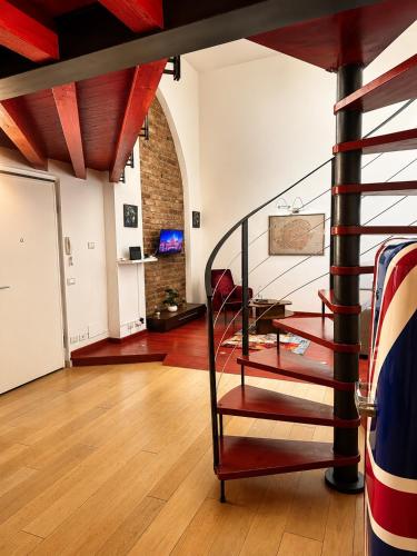 a living room with a spiral staircase in a building at al home in Crema
