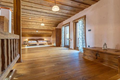 a large living room with wooden floors and a bed at Chalet Vancouver in Donovaly