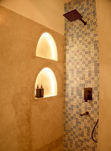 a bathroom with an arched window and a shower at Villa Zuri at Papa Remo in Watamu