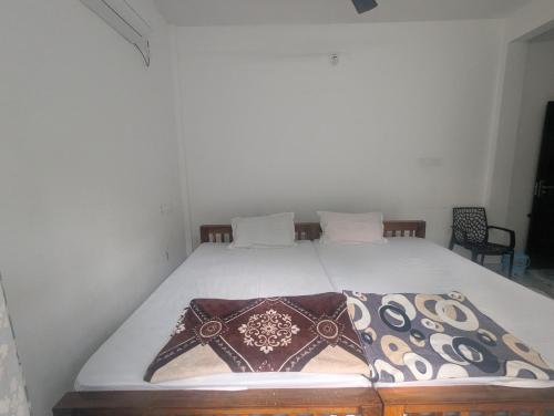 a bed with two pillows on it in a room at Riverside Bliss Villa in Kallar-Bridge
