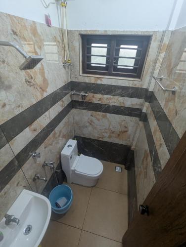 a small bathroom with a toilet and a sink at Riverside Bliss Villa in Kallar-Bridge