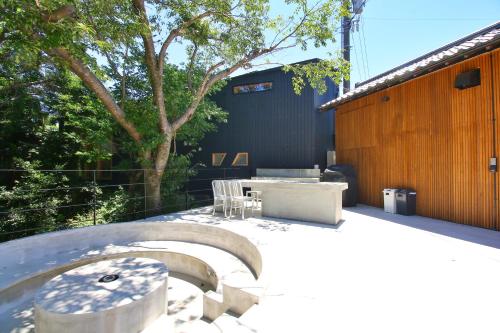 a patio with a table and chairs and a building at Villa KULM in Minamiawaji