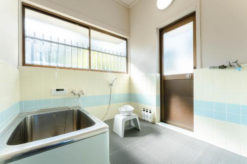 a bathroom with a sink and a toilet in it at Azure Kawatana in Mitsugoe