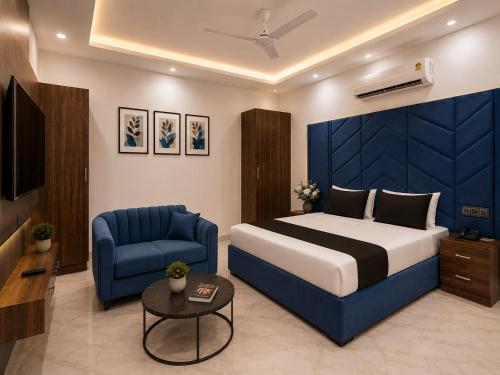 a hotel room with a bed and a chair and a television at Hotel Amar Raja in Kurukshetra