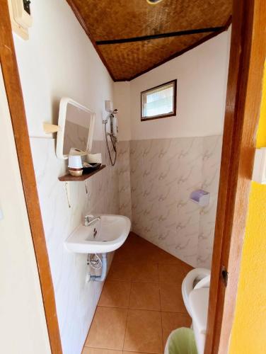 a bathroom with a sink and a toilet at The Countryside Pai in Pai