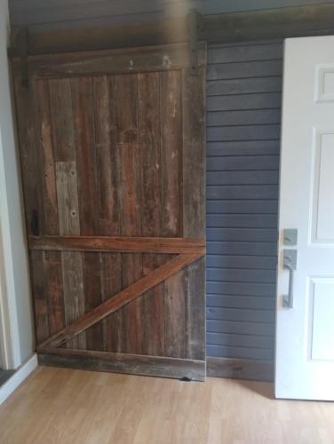 a sliding barn door in a garage at Cozy Private Studio in Des Moines