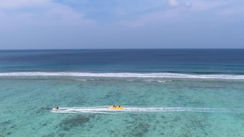 a group of people in a boat in the ocean at The Oceanview Grand at Hulumale and Male in Hulhumale