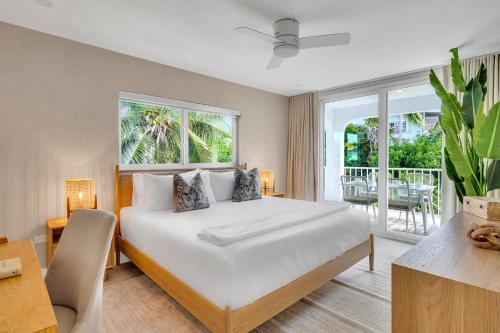 a bedroom with a bed and a large window at Peninsula Villa Boat Dock Heated Pool Sunset Point in Islamorada