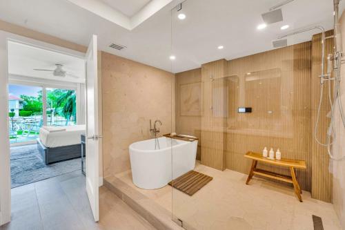 a bathroom with a tub and a shower at Peninsula Villa Boat Dock Heated Pool Sunset Point in Islamorada