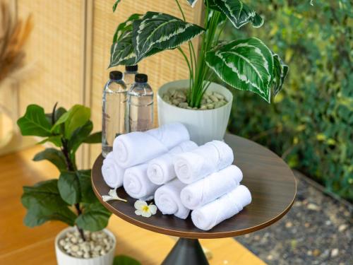 a table with rolls of toilet paper and bottles at The Samui Villa Retreat in Ban Bang Po