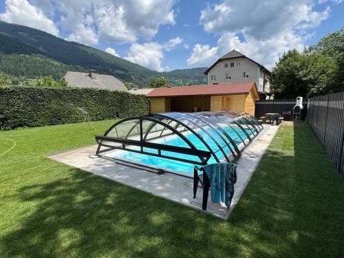 a swimming pool with a metal frame in a yard at Apartment in St Michael near Ski Slopes in Sankt Michael im Lungau