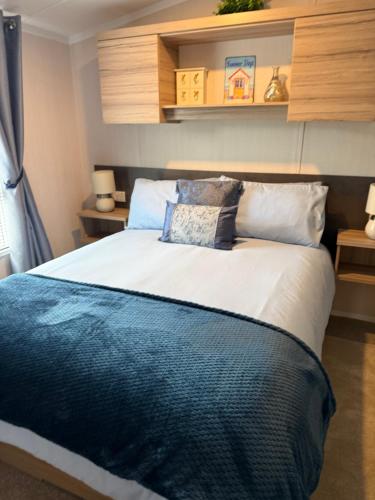 a bedroom with a large bed with a blue blanket at Beach View Eden Heights Kinkell Braes 2 bedrooms 2 bathrooms in St. Andrews