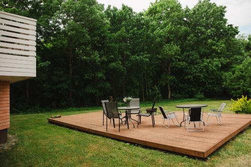 a wooden deck with a table and chairs on it at Konrad Guesthouse in Kuressaare