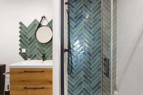 a bathroom with a sink and a mirror at Maison Mendi Borda Pays Basque in Larribar-Sorhapuru