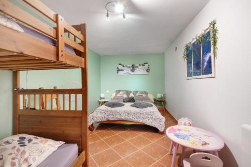 a bedroom with a bunk bed and a ladder at Appartement Type F4 in Maurens