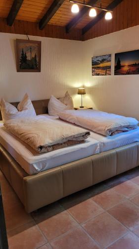 a large bed sitting in a room with at Ferienhaus Bambach in Fladungen