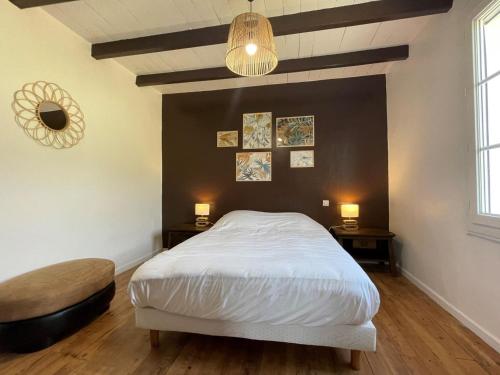 a bedroom with a white bed and a black wall at Elizako bidea in Mendive