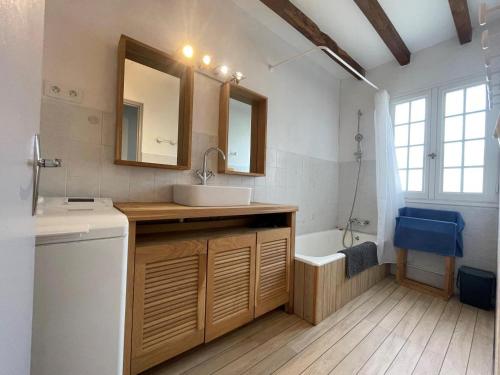 a bathroom with a sink and a mirror and a tub at Elizako bidea in Mendive