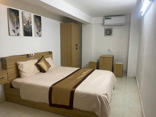 a bedroom with a large bed in a room at Lami House in Danang