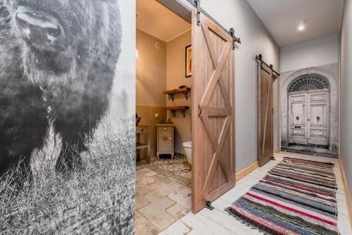 a room with a door and a picture of a horse at Zagroda w Puszczy in Białowieża