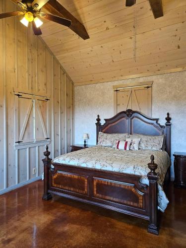 a bedroom with a bed with a wooden ceiling at Breezy Hills Cottages - Moonlight Cottage in Fredericksburg