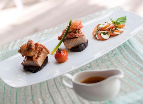 a plate of food on a table with a cup of tea at Olhumathi View Inn in Ukulhas