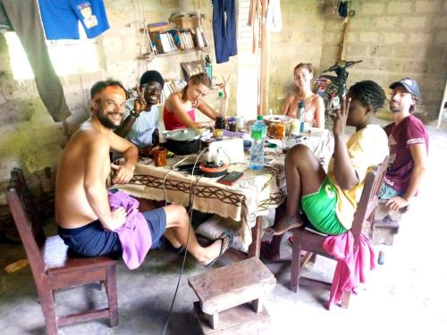 a group of people sitting around a table at SEN-CASA- TOURiSME in Kabadio