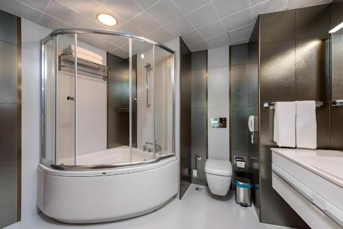a bathroom with a shower and a toilet at The Marilis Hill Resort Hotel & Spa Ultra All Inclusive in Okurcalar