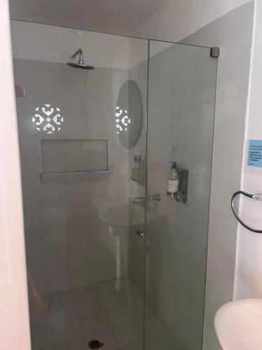 a shower with a glass door in a bathroom at Marine Beach Hotel in Cartagena de Indias