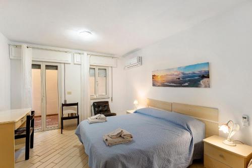 a bedroom with a blue bed and a desk and a desk at Attico Bella Vista in Siniscola