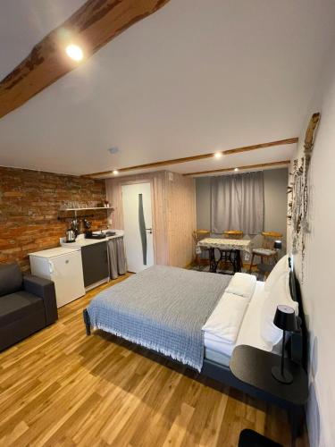 a bedroom with a large bed and a kitchen at Pāvilostas Piparmētras in Pāvilosta