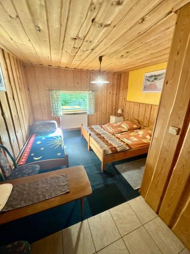 a small room with two beds and a couch at Agroturystyka Kociewiak in Szteklin