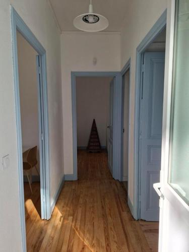 an empty room with a hallway with wood floors at Appartement avec jardin privé à 5 min du Cheylard & Dolce Via - Vacances natures, vélo & randos in Accons
