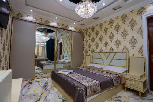 a bedroom with a bed and a mirror at Family Hotel in Khujand