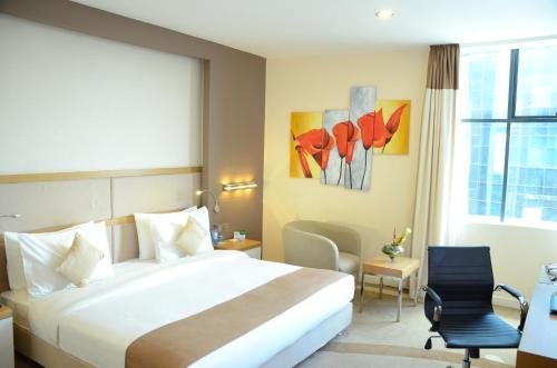 a hotel room with a large bed and a window at PrideInn Azure Hotel Nairobi Westlands in Nairobi