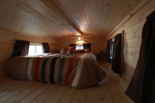 A bed or beds in a room at Verde Valley Tiny House 17