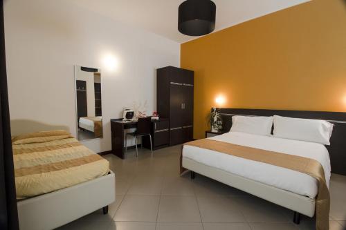a hotel room with two beds and a desk at Hotel Panama Majestic in Rimini