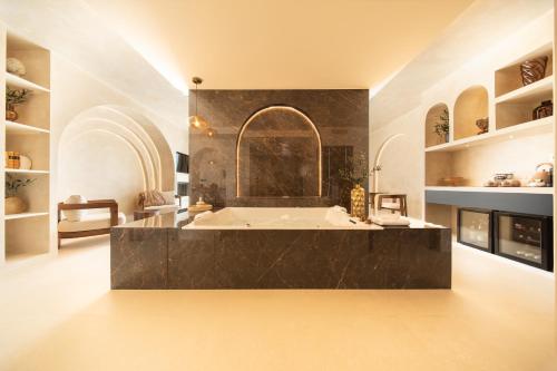 a large bathroom with a large tub in a room at La Bastide des Rameaux - Boutique Hôtel & Spa in Callas