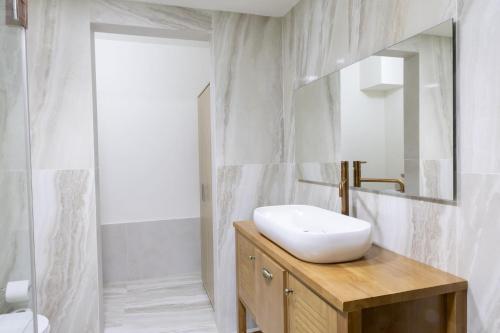 a bathroom with a sink and a mirror at Villa Sun Bay in Eilat