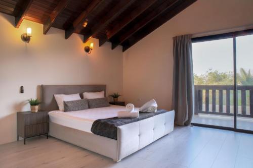 a bedroom with a large bed and a large window at Villa Sun Bay in Eilat