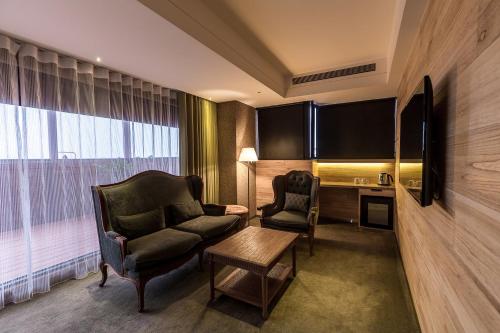a hotel room with a couch and a table at Inhouse Hotel Taichung in Taichung
