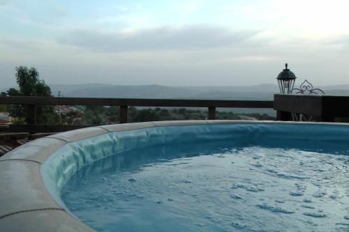 a swimming pool with a view of the ocean at Betzel Ha'Ella in Kahal