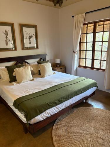a bedroom with a large bed in a room at Tulani Boutique Lodge - Includes Game drives and Meals in Grietjie Game Reserve
